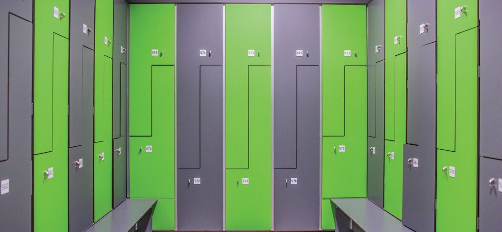 HPL lockerkast met gele volkern Z deur en smal bankje, frontaal weergegeven.